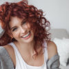 Woman with red curly hair styled with Juicy Curls