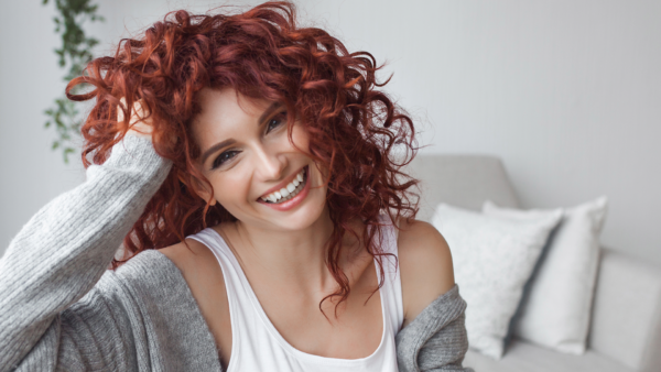 Woman with red curly hair styled with Juicy Curls