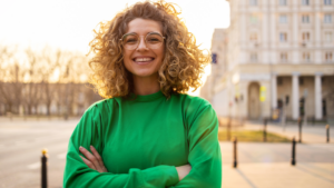 Portrait of young woman with curly hair in the city